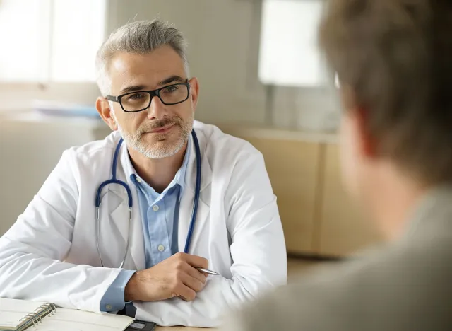 Doctor talking to patient in office