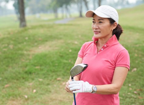 Portrait of cheerful Vietnamese golf player