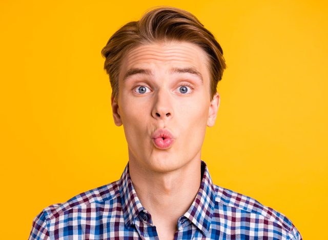 Close up photo amazing youngster he him his man excited look wondered lips mouth perfect ideal o shape figure form wear casual plaid checkered shirt outfit isolated yellow bright background
