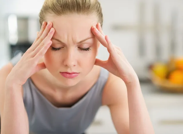 Portrait of stressed young housewife in modern kitchen