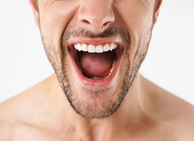 Cropped photo closeup of excited naked man screaming at camera with emotional face isolated over white background