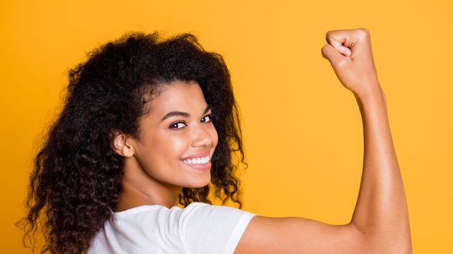 Close-up profile side view portrait of her she nice attractive lovely brunet cheerful wavy-haired girl showing strong muscles isolated over bright vivid shine vibrant yellow color background