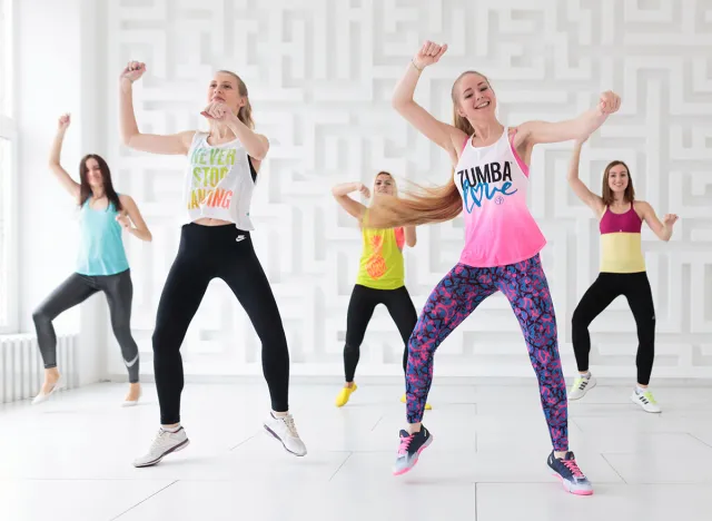 RUSSIA, MOSCOW, 2017 - MARCH 12: Group of young women in sportswear at Zumba dance fitness class in white Zumba studio