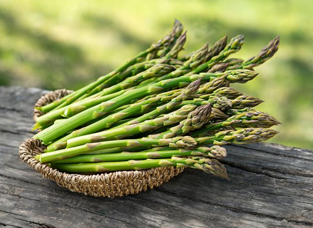Asparagus. Fresh Asparagus. Pickled Green Asparagus. Bunches of green asparagus in basket, top view- Image