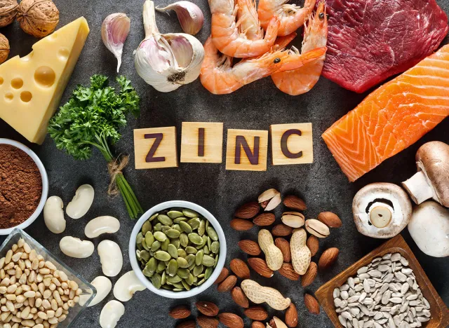 Foods High in Zinc as salmon, seafood-shrimps, beef, yellow cheese, parsley leaves, mushrooms, cocoa, pumpkin seeds, garlic, bean, almonds, pine nut. Top view