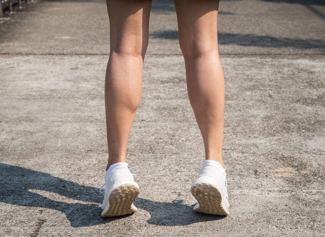 Cropped shot of female runner standing on her tiptoes for strengthen her calves. Toe stretches can help keep you healthy and prevent common runner injuries.
