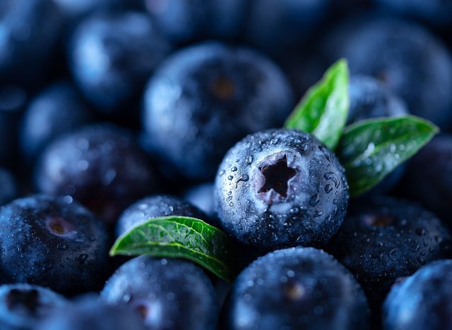 Blueberries with leaves. Macro shot of blueberries background. Superfoods concept, front view. Healthy food