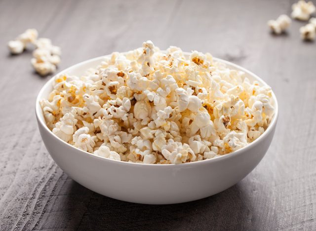 Olive oil popped popcorn in a porcelain bowl horizontal shot