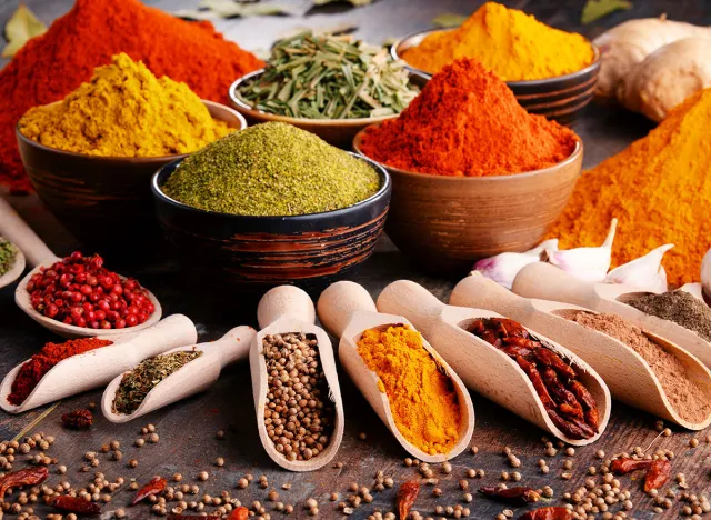 Variety of spices and herbs on kitchen table.