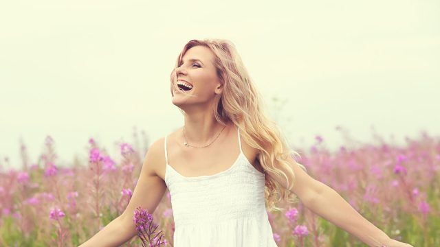 outdoor portrait of a beautiful middle aged blonde woman. attractive sexy girl in a field with flowers