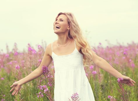 outdoor portrait of a beautiful middle aged blonde woman. attractive sexy girl in a field with flowers