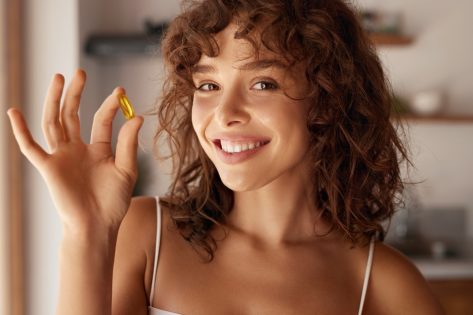 Happy Smiling Woman Holding Pill