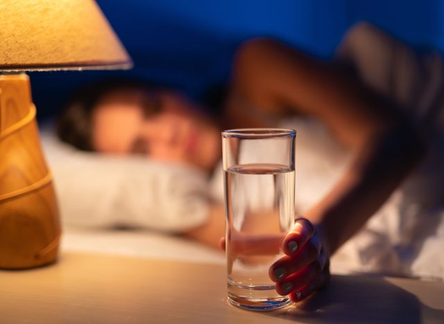 The sleeping woman holding an alcohol shot