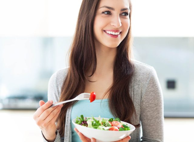 Woman eating salad