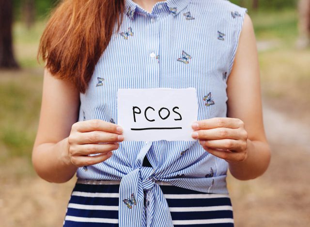 PCOS - Polycystic ovary syndrome, woman hormone sickness lettering on paper in womans hands