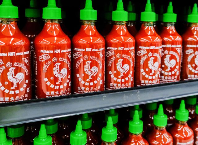 Los Angeles, CA/USA 08/21/2019 Plastic bottles of Huy Fong Food Sriracha hot chili sauce in a supermarket aisle