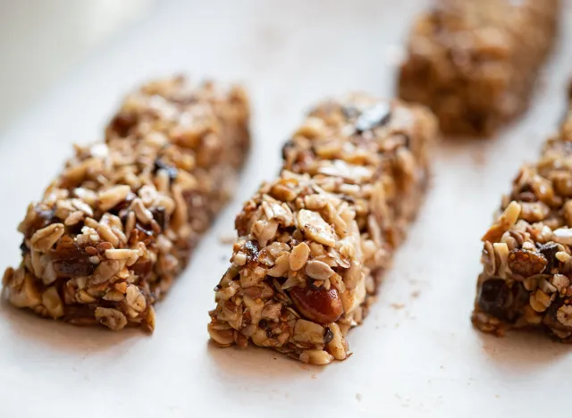 mussli or cereal bars, full of nuts and chocolate, on a white background, healthy breakfast or snack