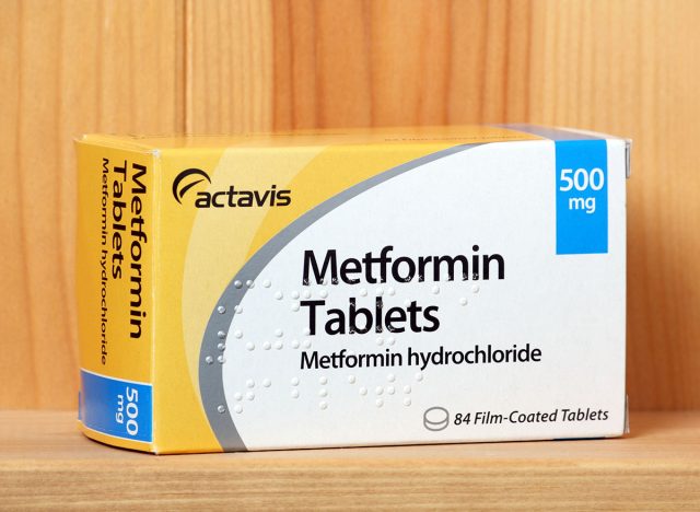 BRACKNELL, ENGLAND - JANUARY 14, 2014: A box of Metformin tablets produced by the pharmaceutical company Actavis, on a wooden shelf. Metformin is an oral treatment for type 2 Diabetes.