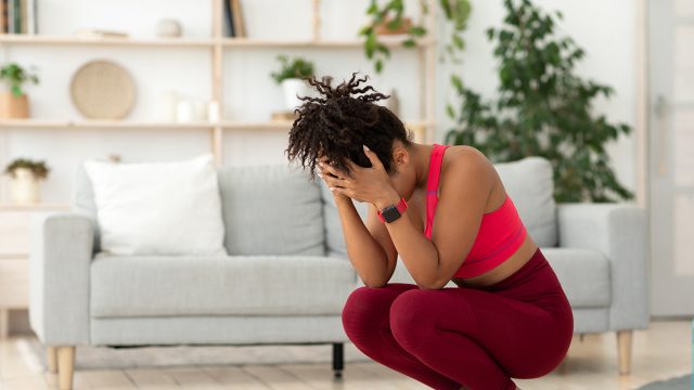 Weight Gain. Desperate Black Girl Crying Standing On Weight-Scales Slimming, Not Losing Weight On A Diet At Home. Copy Space