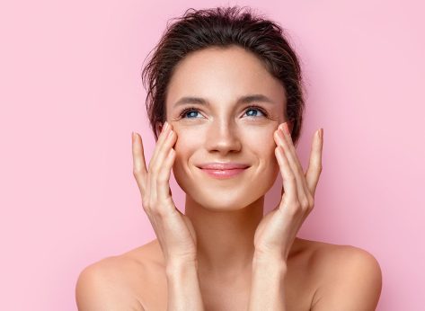 Beautiful woman with perfect skin on pink background. Beauty and skin care concept