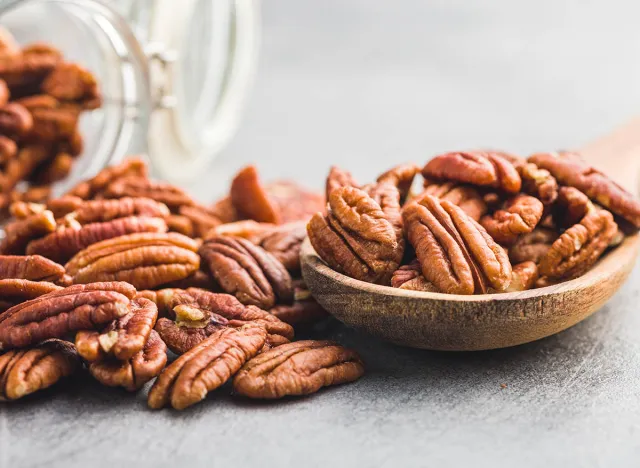 Peeled pecan nuts in the wooden spoon.