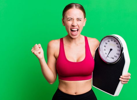 caucasian pretty woman shouting aggressively with an angry expression. fitness and diet concept