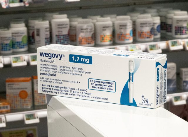 Packaging box of Wegovy (semaglutide) injectable prescription medication, weight-loss drug from Novo Nordisk AS. Pharmacy shop shelves in background. Copenhagen, Denmark - November 13, 2023.