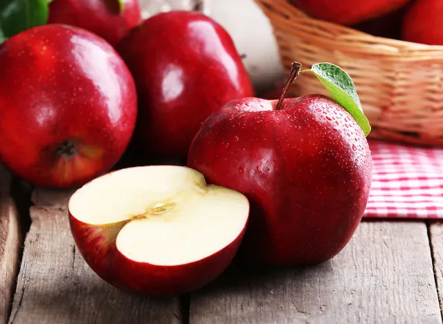 Ripe red apples on table close up