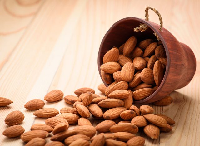 Almonds pour from wood Cup