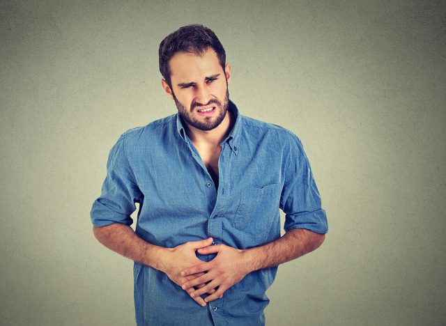 Young man with stomach pain indigestion