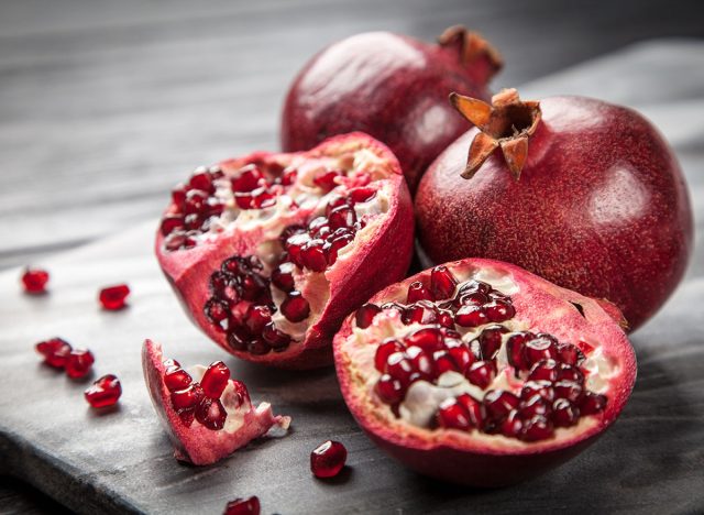 Red juice pomegranate on dark background