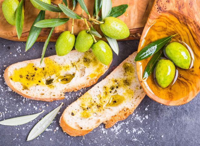 Olive oil and olives, bread with oil.Testing fresh mediterranean extra virgin olive oil.