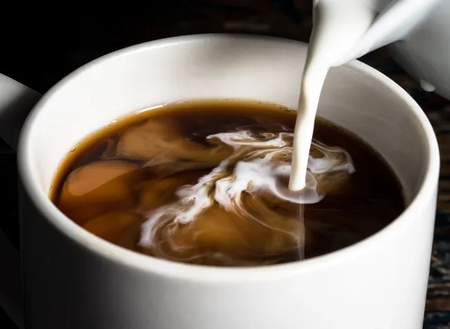 Pouring Cream into a Cup of Coffee