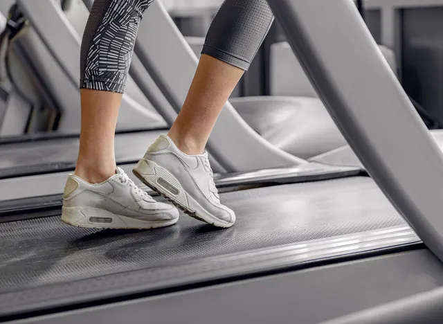 Legs of woman running on treadmill