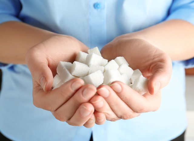 Female hands holding sugar cubes, closeup