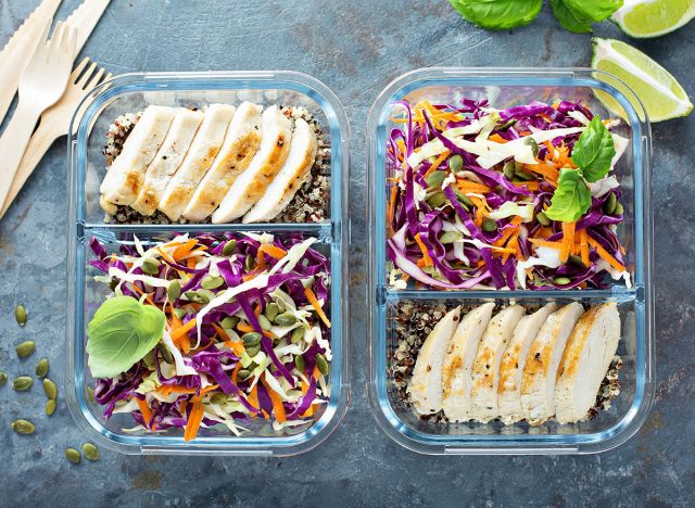 Healthy meal prep containers with quinoa, chicken and cole slaw overhead shot