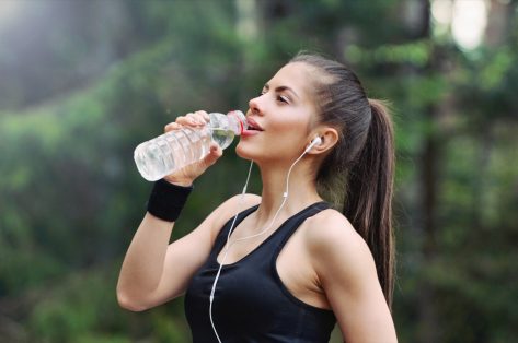 fitness sporty woman running early in the morning in forest area, healthy lifestyle concept