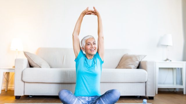 Mature woman workout before fitness training session at home.