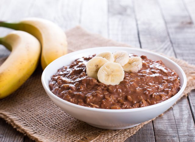 Raw oatmeal porridge with banana and chocolate. Healthy breakfast