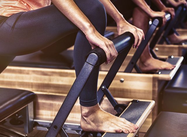 Group of women exercising on reformer in gym