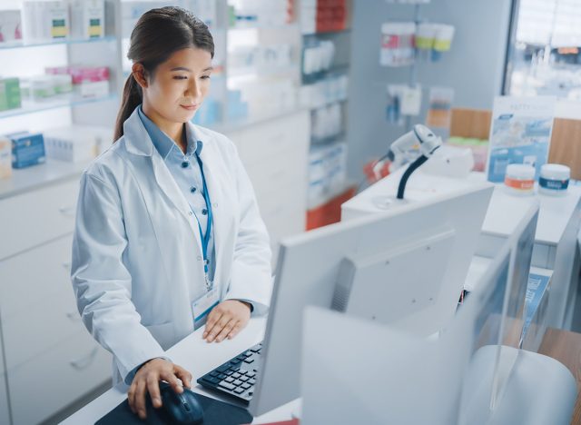 Pharmacy,Drugstore:,Beautiful,Asian,Pharmacist,Uses,Checkout,Counter,Computer,,Does