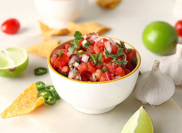 Bowl of tasty Pico de Gallo salsa on table