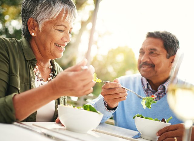 Healthiness and happiness go hand in hand. Shot of a happy older couple enjoying a healthy lunch together outdoors.