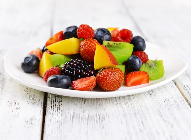 Delicious fruits salad in plate on table close-up