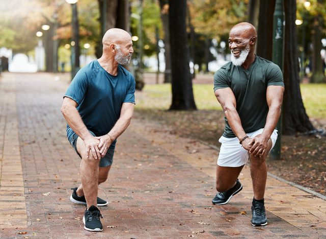 Elderly men, training and stretching for morning workout in the park or forest. Senior, lunges exercise and motivation for wellness, fitness and healthcare strong legs cardio or running outdoors