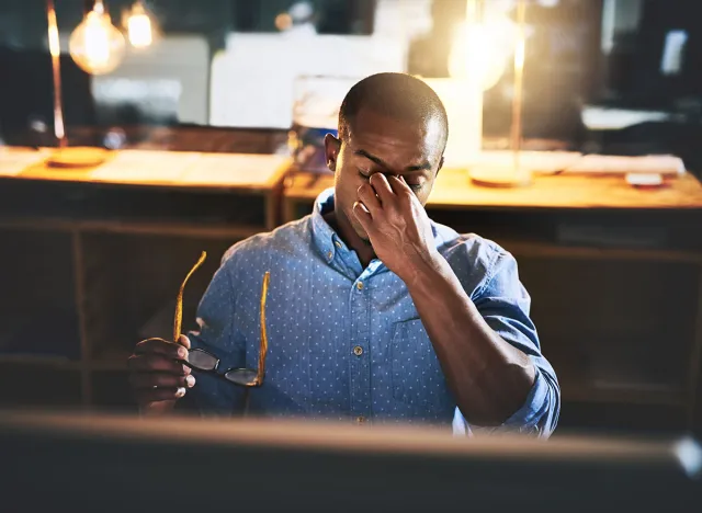 Black man in business, night and headache with stress and vision problem, crisis and burnout from overtime. Professional male with migraine, brain fog and work late with loss of focus and overworked