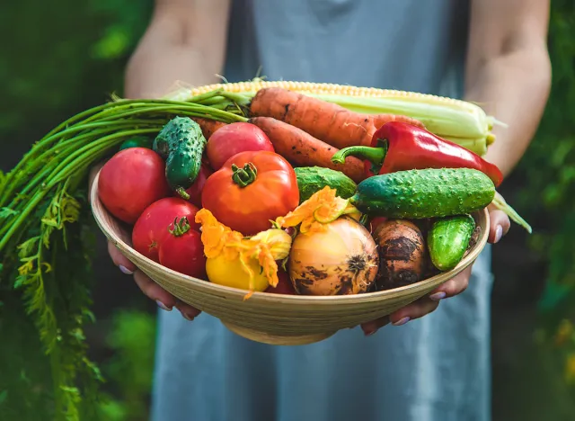 Farmer woman harvests vegetables in the garden. Selective focus. Food.