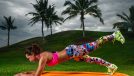 Slim fitness young woman Athlete girl doing plank exercise outside. Concept training workout crossfit gymnastics cross fit.