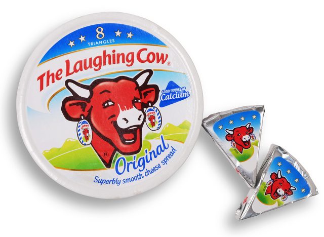 Scarborough, UK - February 16th, 2016: Pack of Laughing Cow spread cheese shot from above isolated on white with path. Created in 1921, the first cheese spread packaged in individual foil portions