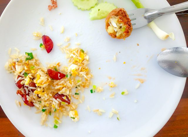 Left-over food . Check bill . Pay for food after eating out . empty plate and fork and spoon .